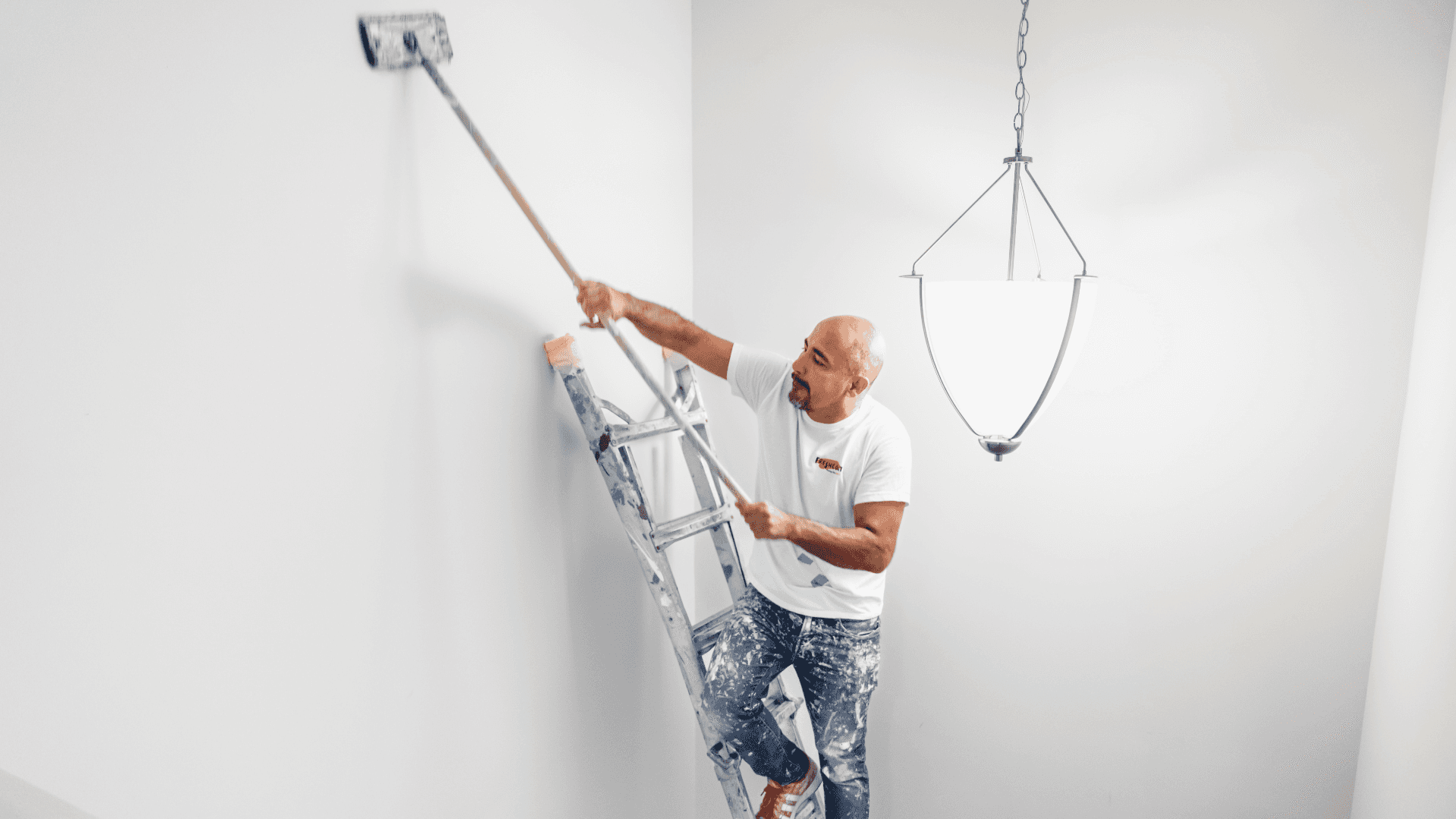 Photo of Fresh Coat Painters team member working on ladder