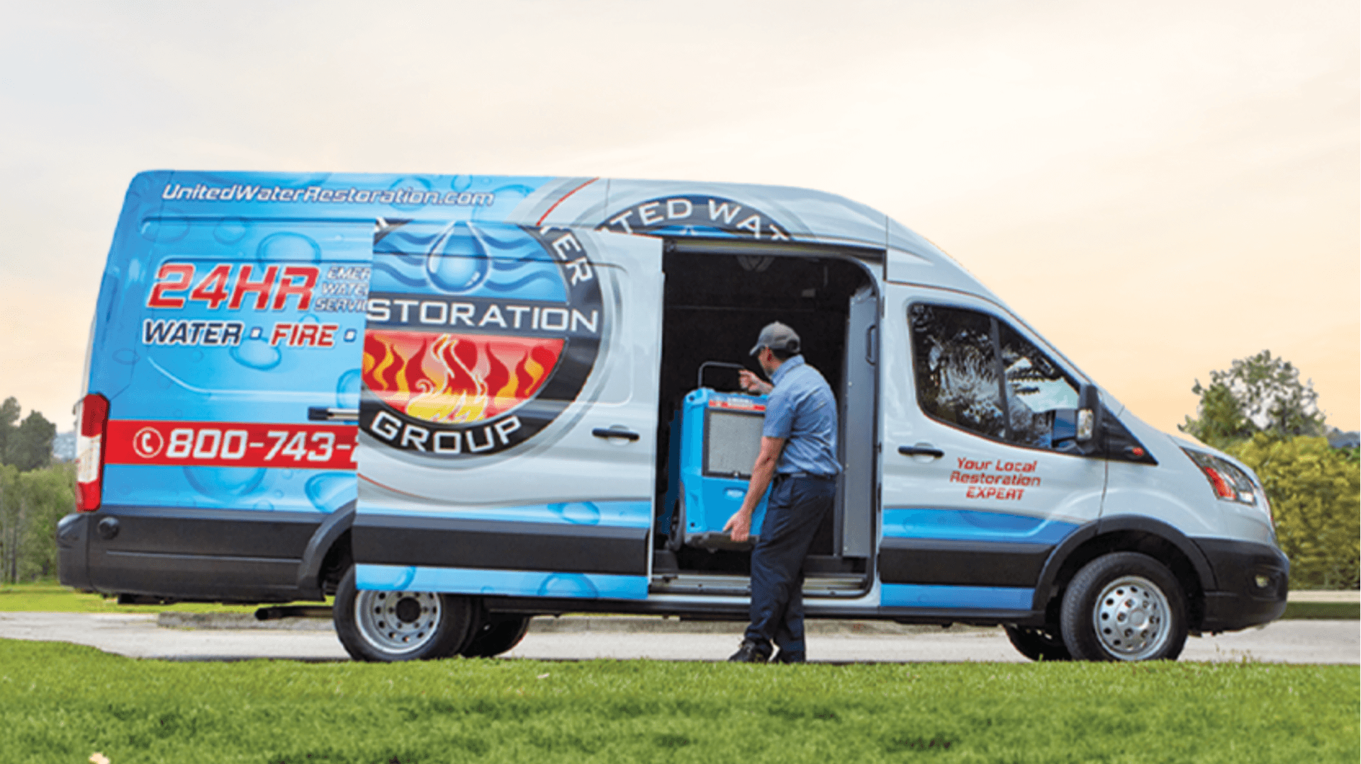 Photo of United Water Restoration Group van and team member unloading equipment