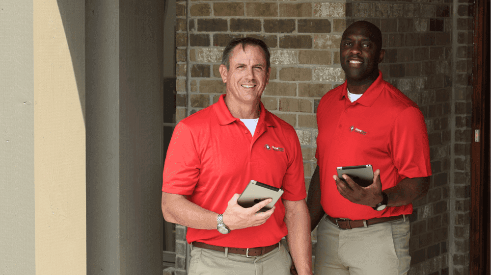 How HomeTeam Inspection Service’s Team-Based Model Photo of two HomeTeam Inspection Service inspectors outside a home