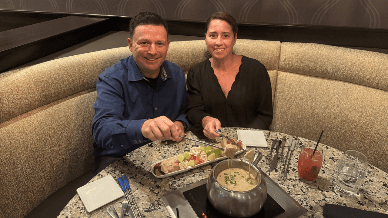 Love Stories and Family Traditions: How the Reeves Brought Melting Pot Back to Their Community photo of Daina and Jonathan Reeve sharing a meal at a Melting Pot table