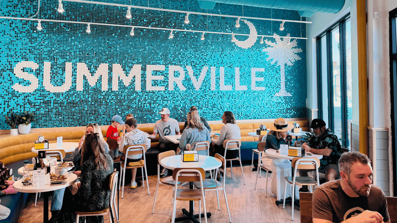 How undefined Evolved and Set New Standards Photo of interior of Biscuit Belly Summerville featuring blue tile wall, tables with seated guests