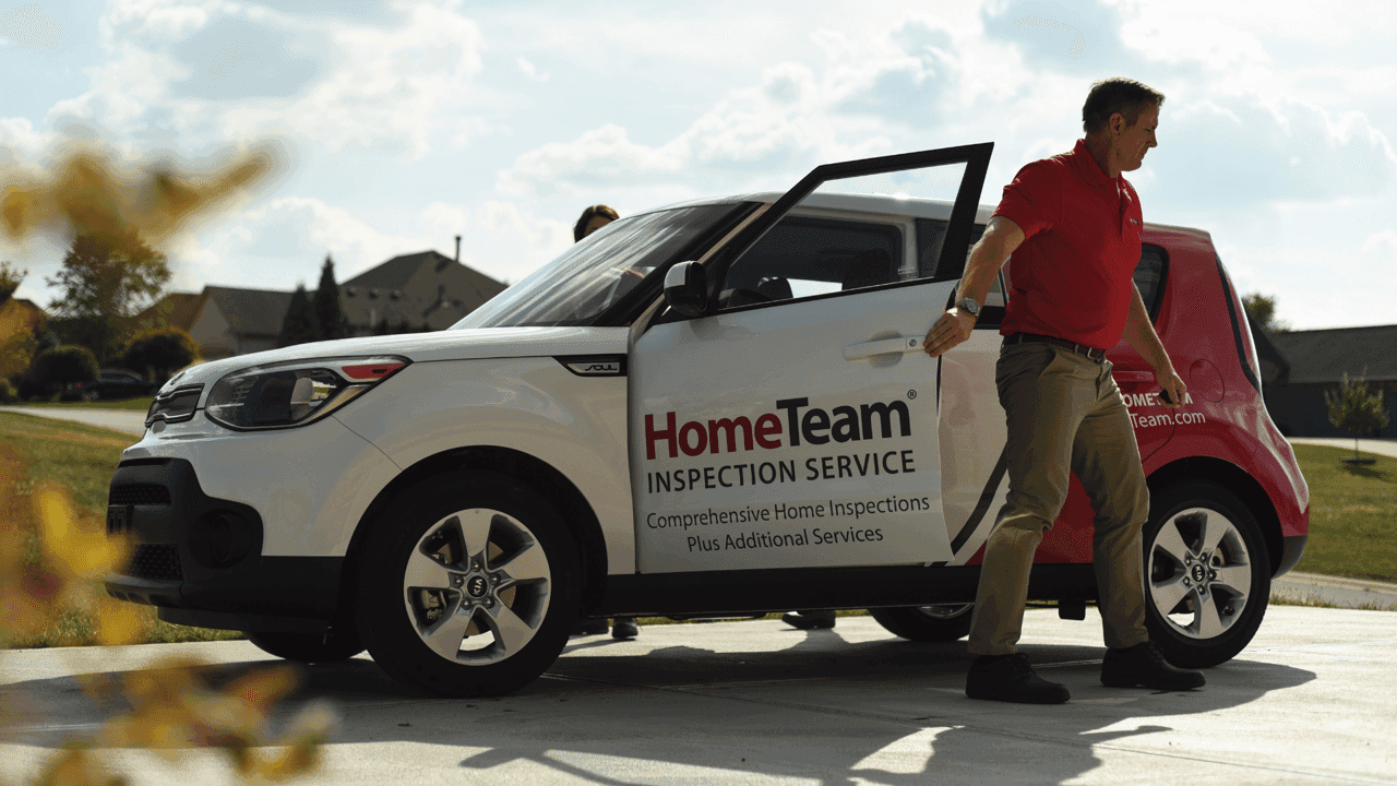 How undefined Evolved and Set New Standards Photo of HomeTeam team member exiting branded vehicle in khakis and red polo