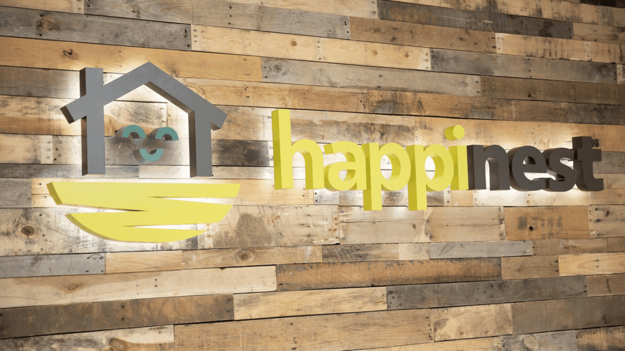 How undefined Evolved and Set New Standards image of a happiness business franchise logo on a wood wall on location