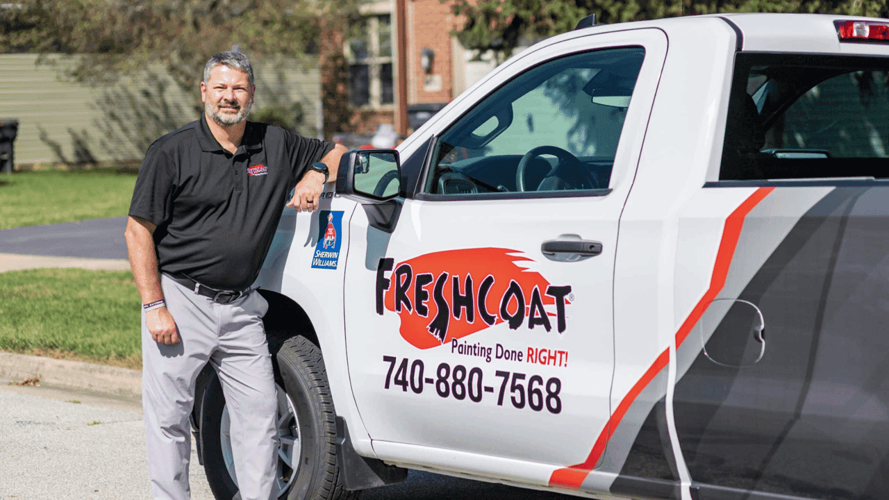 How undefined Evolved and Set New Standards Photo of Fresh Coat owner standing by branded vehicle