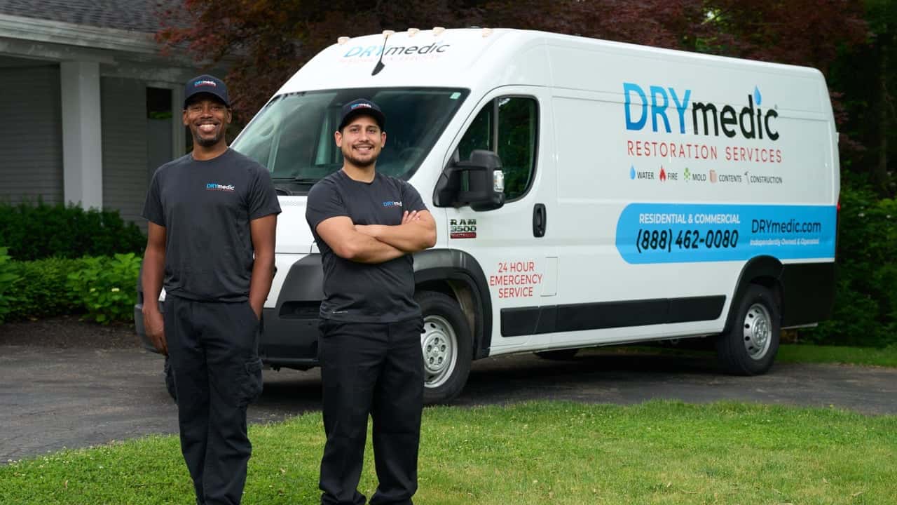 How undefined Evolved and Set New Standards Photo of two DRYmedic team members standing in front of branded vehicle