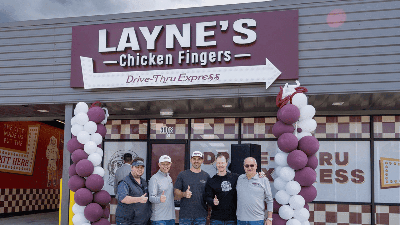 Layne’s Opens Three Houston Restaurants in Four Months, photo of five Layne's Chicken Fingers team members standing in front of new drive-thru only Layne's