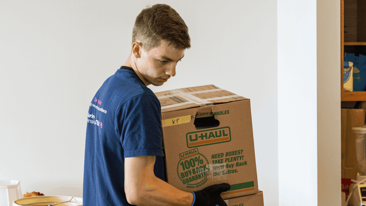 How undefined Evolved and Set New Standards image of a man carrying boxes for a disabled person for caring transitions in a small town