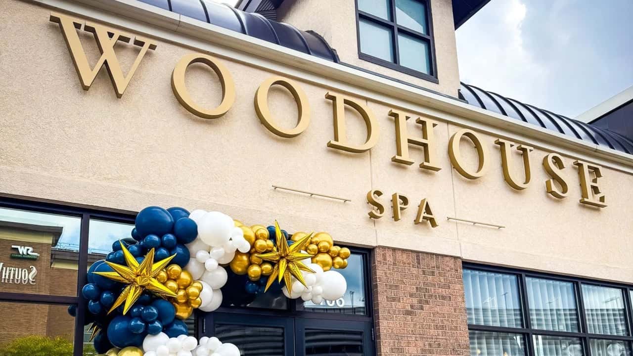 Woodhouse Spas Names Florida Its Next Major Growth Target Photo of exterior of Woodhouse Spa location with navy blue, white and gold balloons