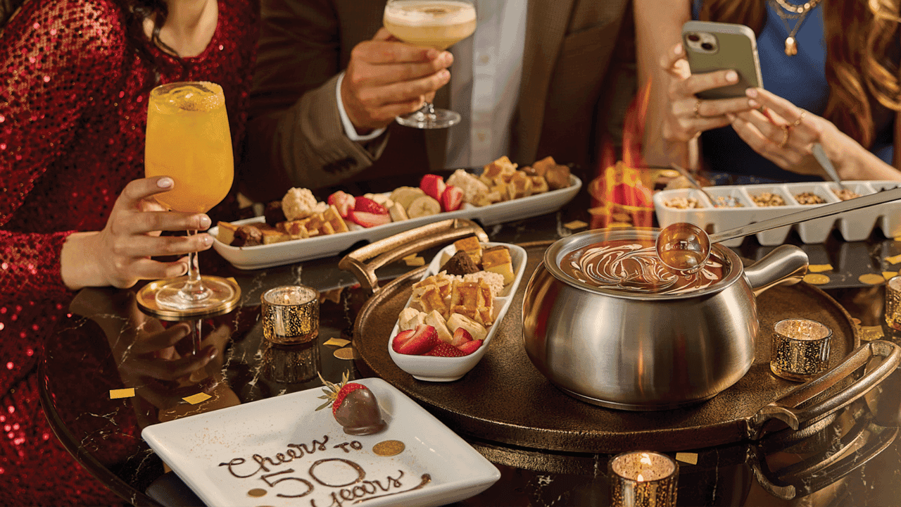 How undefined Evolved and Set New Standards Photo of Melting Pot table with chocolate fondue and "Cheers to 50 Years" plate