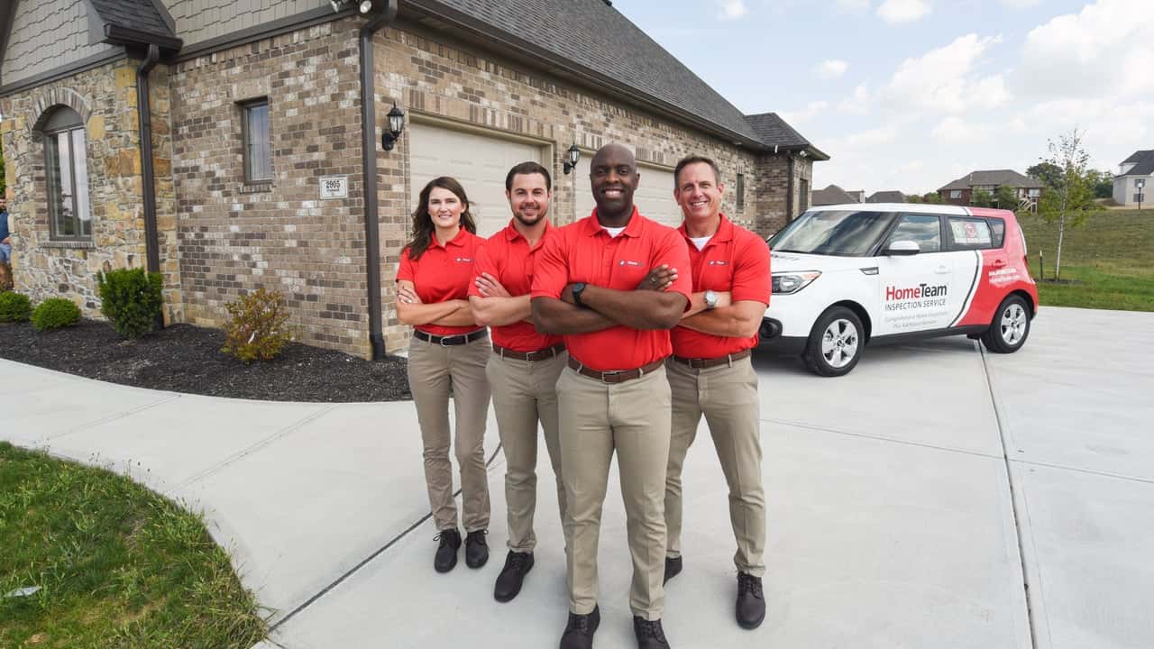 Top 5 Reasons to Buy a HomeTeam Inspection Service Photo of four HomeTeam inspectors standing together outside home