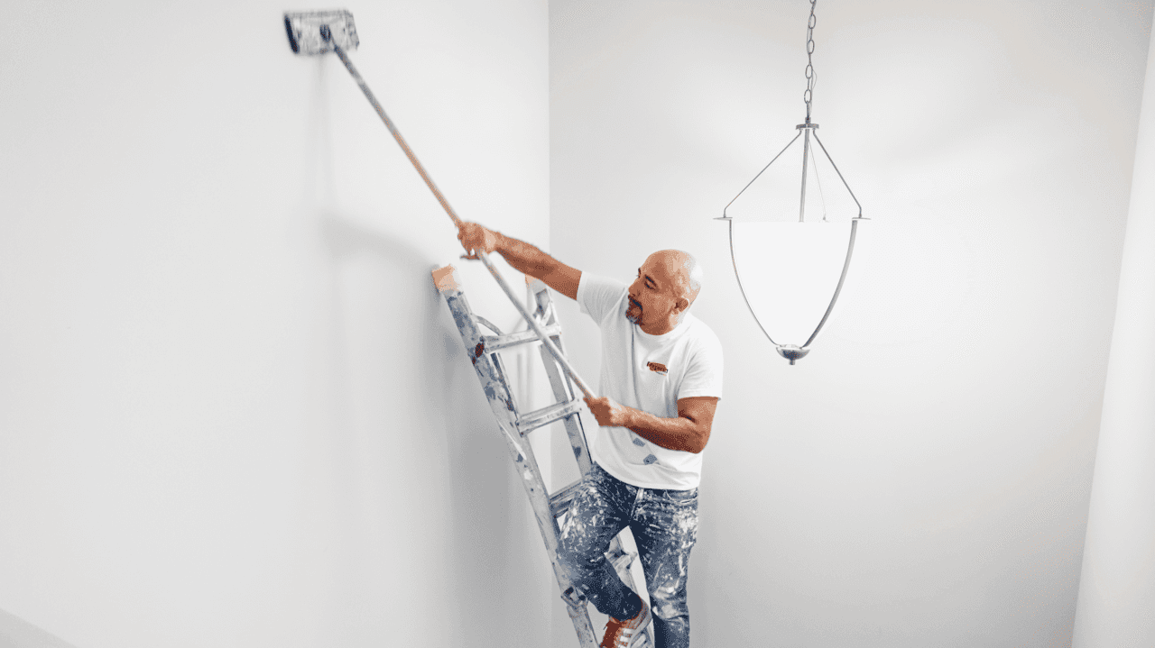 Keys to Team Retention for Fresh Coat Painters Franchisees Photo of Fresh Coat Painters team member working on ladder