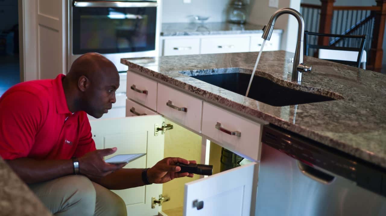 How undefined Evolved and Set New Standards Photo of HomeTeam inspector in kitchen