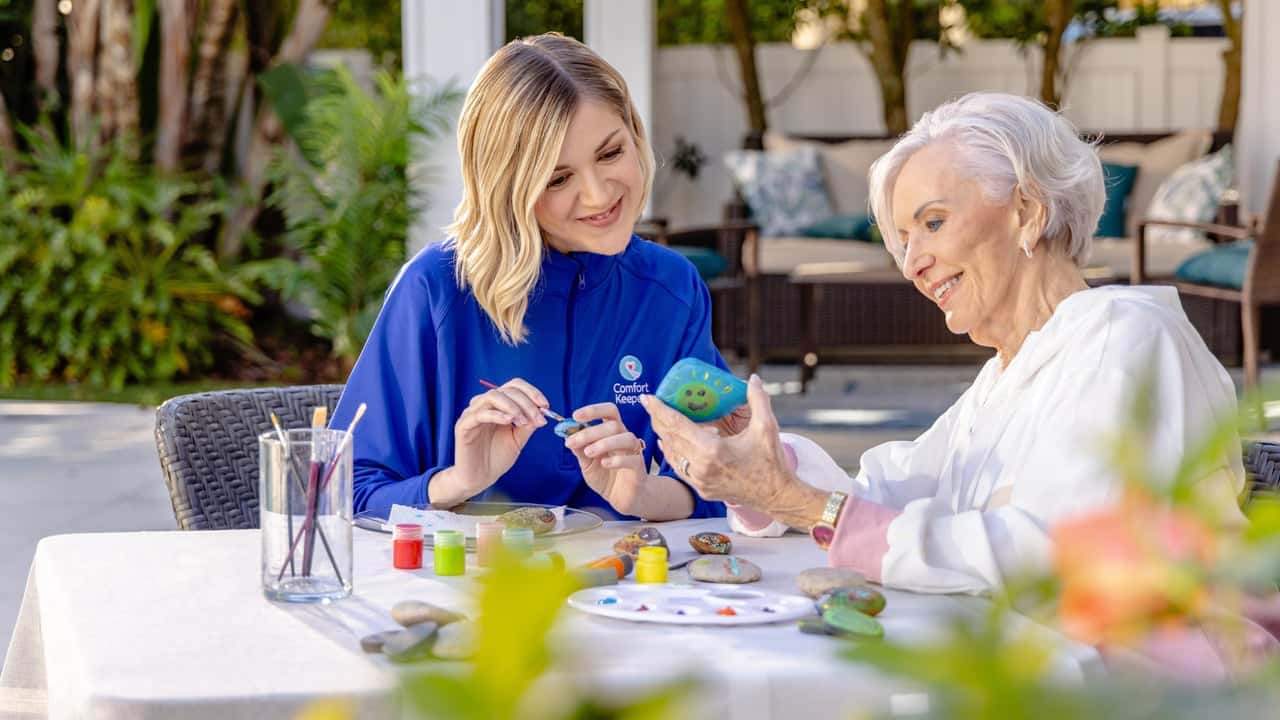Comfort Keepers® Opens 3 New In-Home Care Franchise Photo of Comfort Keepers team member and senior completing craft project