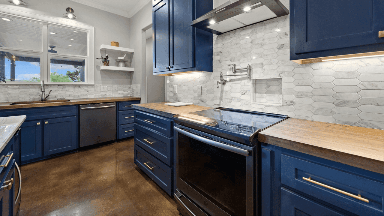 How undefined Evolved and Set New Standards Photo of kitchen space with wooden counters, navy blue cabinets, and white and gray backsplash